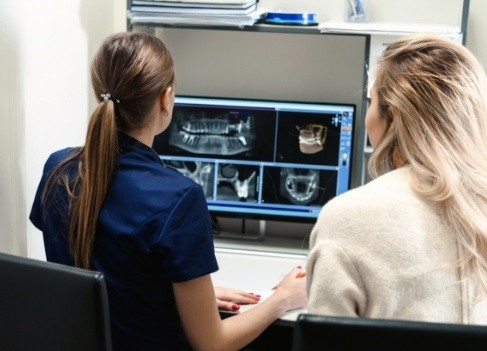 Dental team members looking at all digital x rays