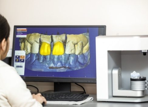 Dentist designing new smile with digital impression system