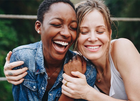 Veneers patient in Anaheim smiling with a friend