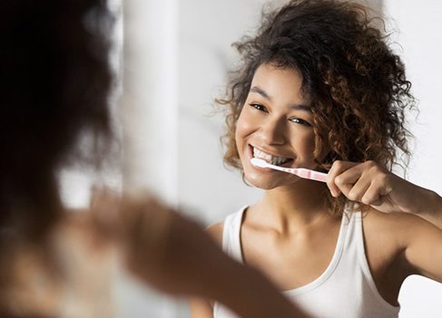 Patient in Anaheim brushing after teeth whitening