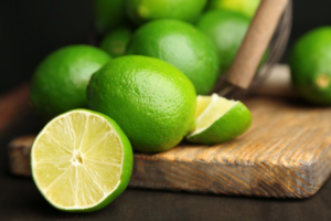 An aesthetic arrangement of limes on a wood cutting board