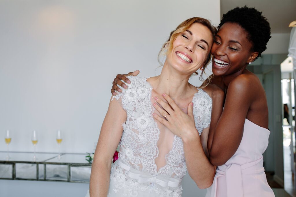 Bridge and bridesmaid smiling for photo